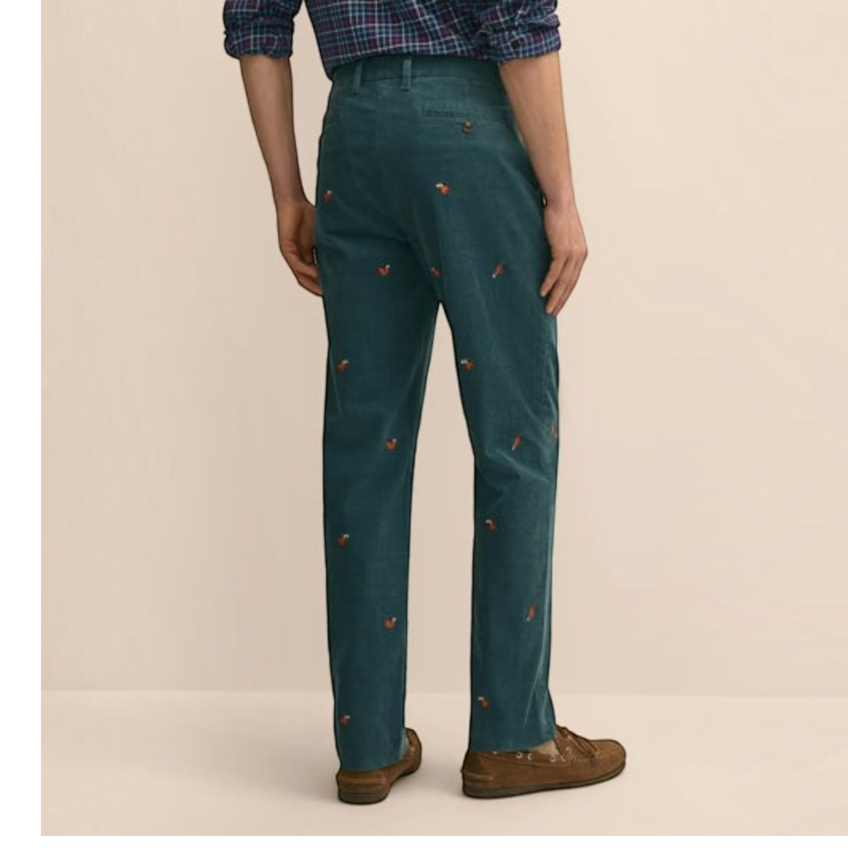 MILWORKS dark green cotton corduroy pants featuring a playful squirrel embroidery pattern, shown from the back view.