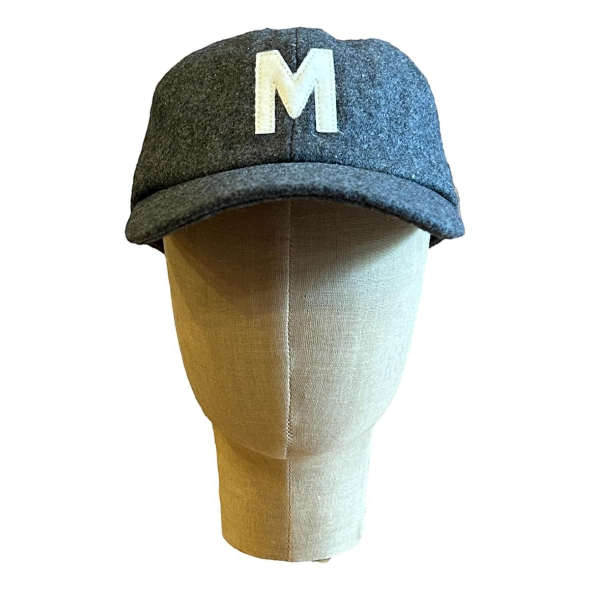 MILWORKS grey wool fieldhouse cap with a white felt "M" logo on the front. Unstructured cap with flat peak.
