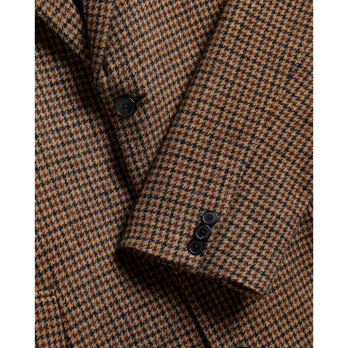 MILWORKS Portuguese Flannel overcoat featuring a classic brown and black houndstooth pattern with black button cuffs.