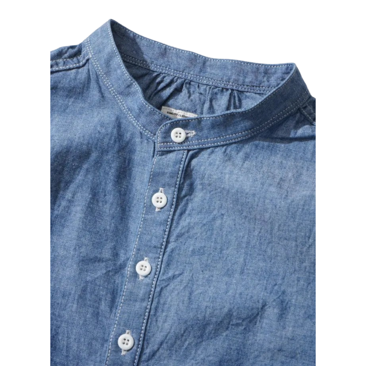 MILWORKS indigo chambray pullover work shirt with a band collar, white buttons, and gathered neckline detail.