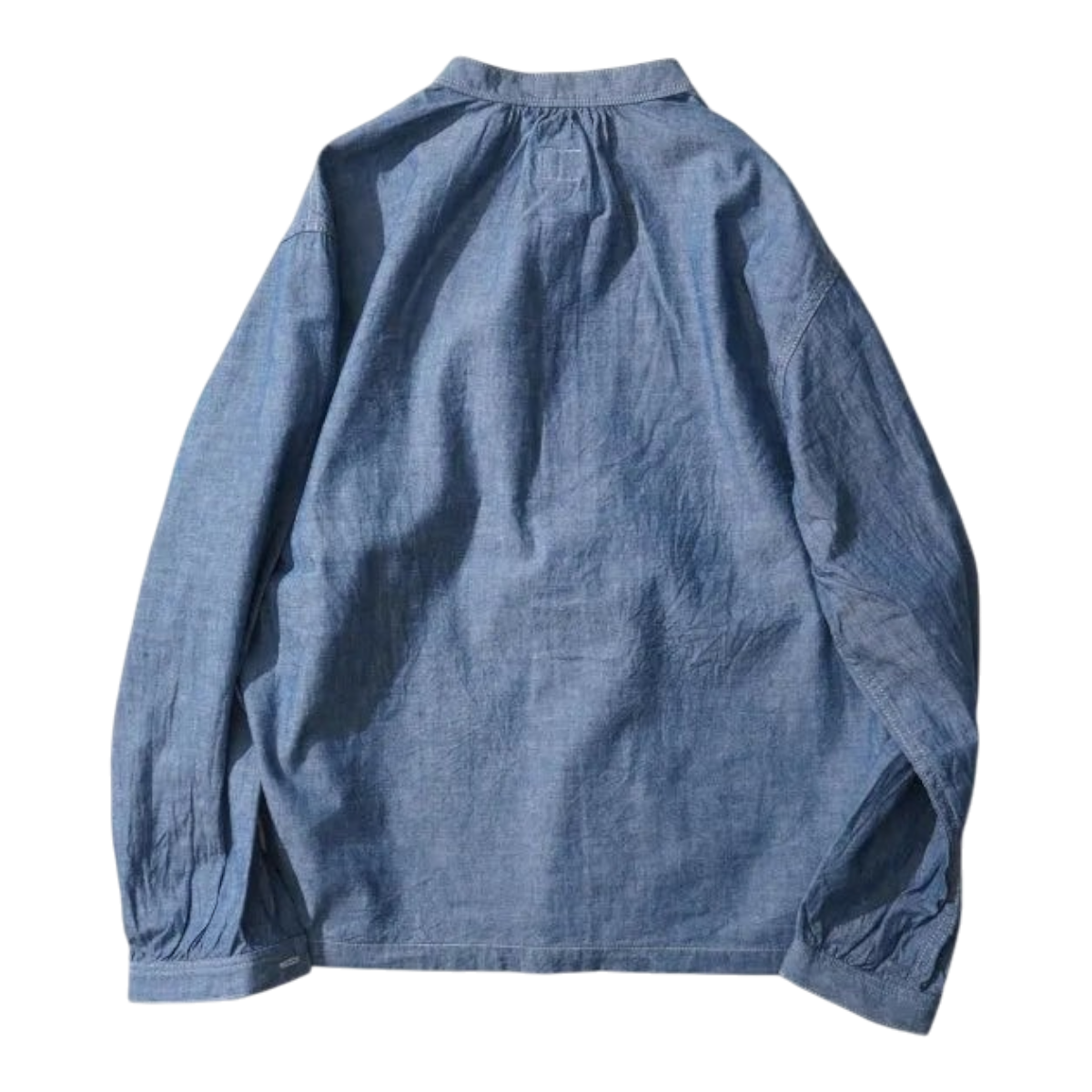 Back view of a MILWORKS indigo chambray pullover work shirt in 100% cotton with a relaxed boxy fit.