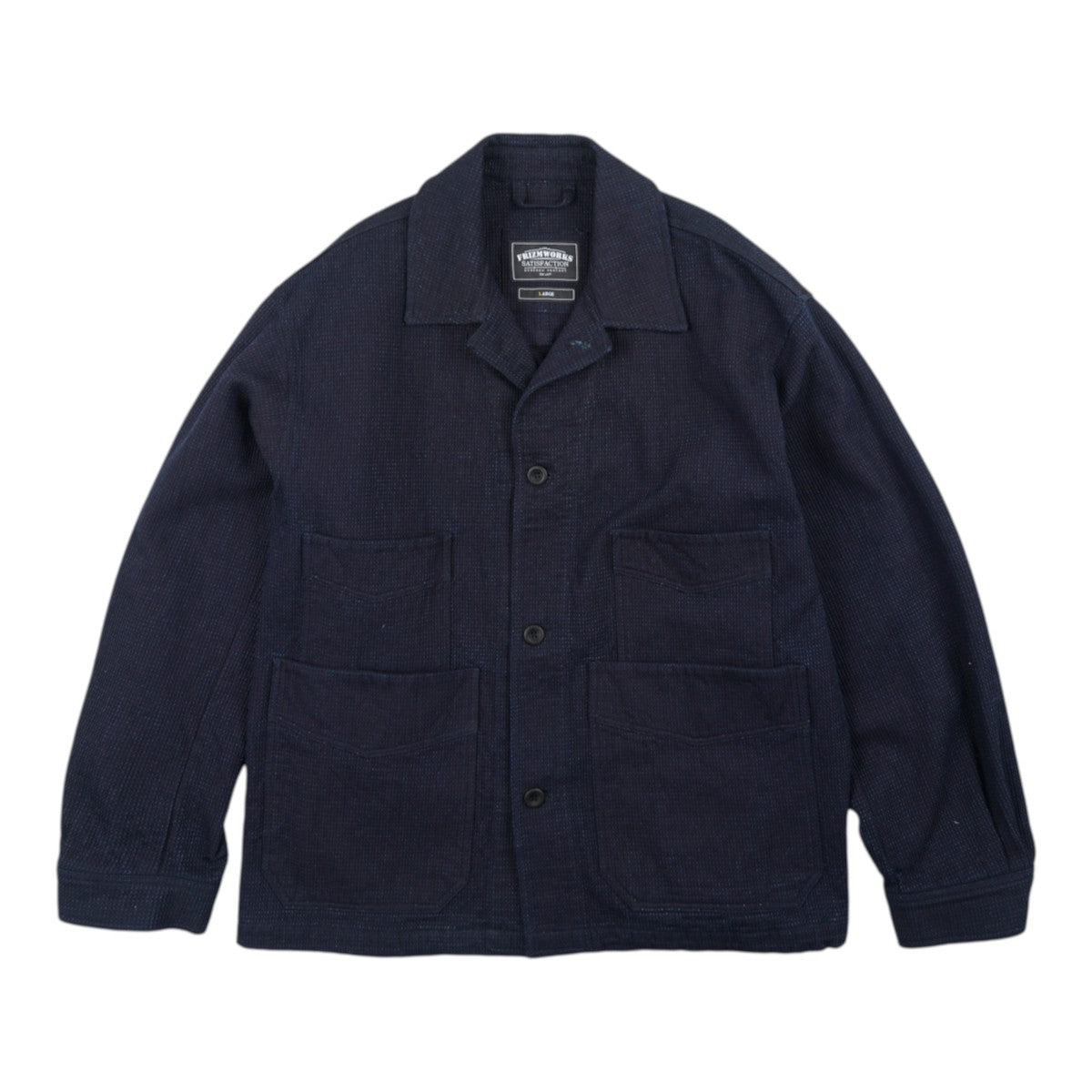 MILWORKS indigo sashiko coverall jacket with double chest pockets, button front, and textured stitching.