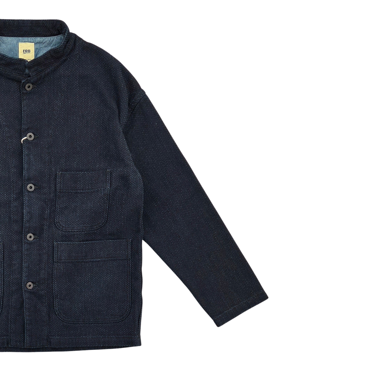 MILWORKS F.O.B Factory indigo sashiko jacket with a mandarin collar, button front, and two patch pockets.