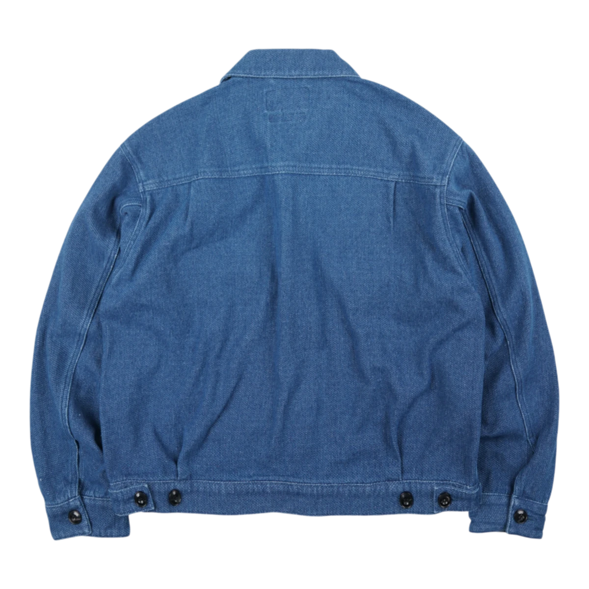 Back view of a MILWORKS mid-blue indigo sashiko trucker jacket with reinforced seams and buttoned cuffs.
