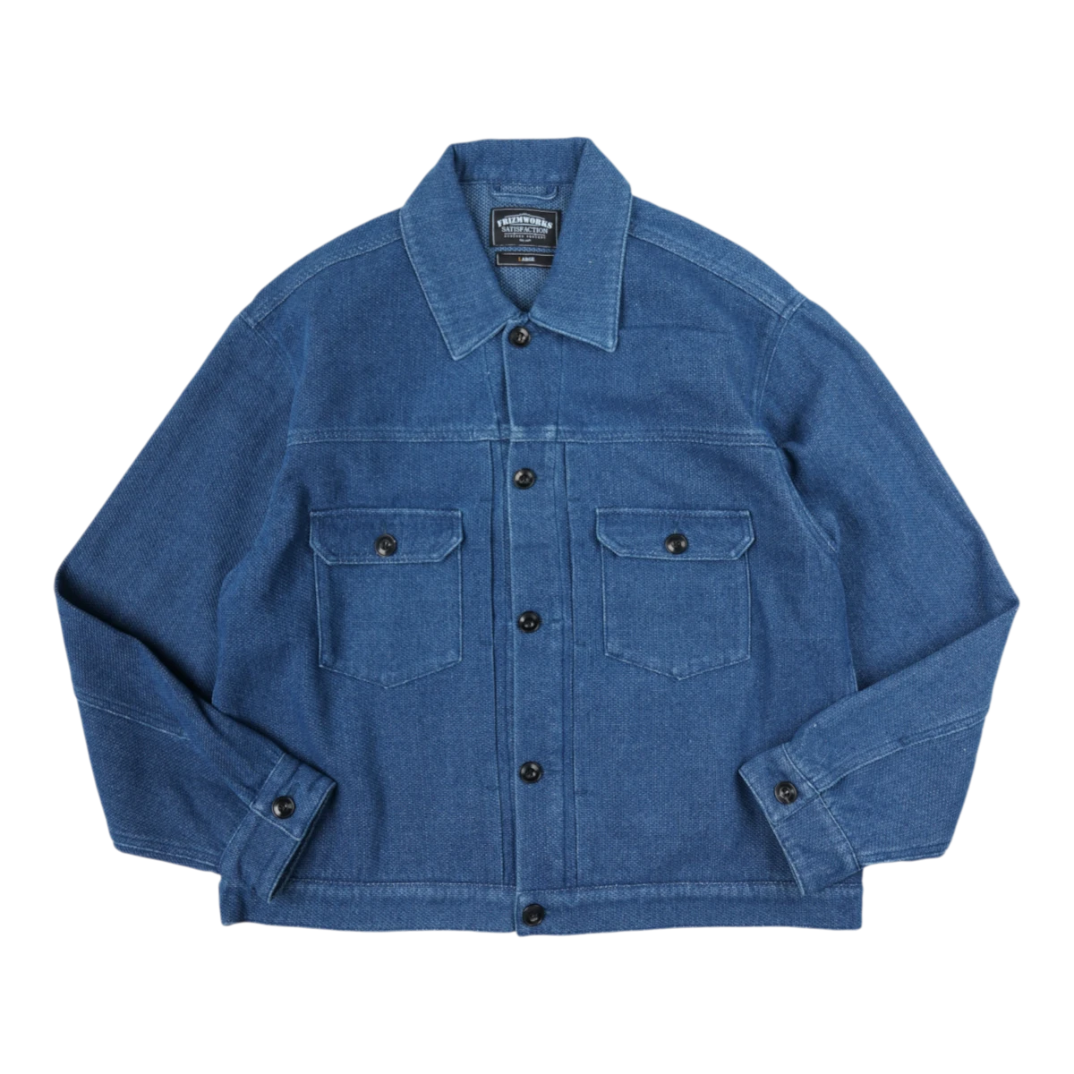 MILWORKS indigo sashiko trucker jacket in mid blue with button-up front, dual chest pockets, and structured collar.