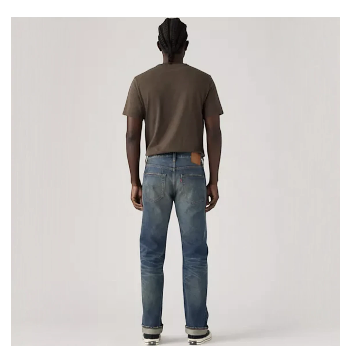 Back view of a man wearing MILWORKS Levi's 501 Original Nevada Farmers Selvedge jeans with a worn blue wash.