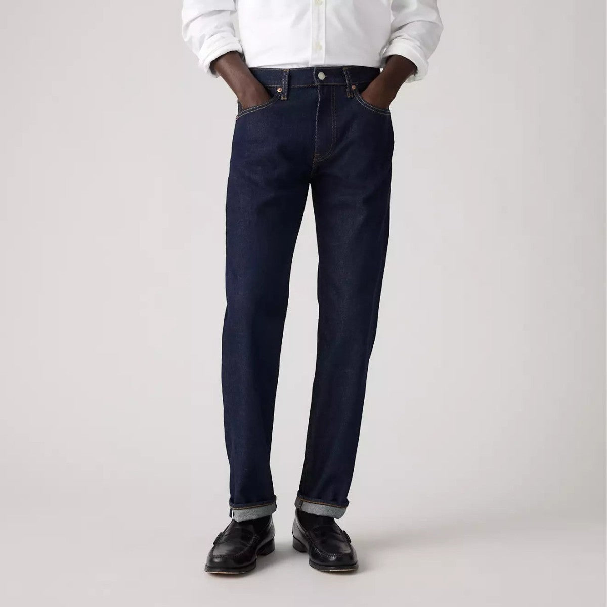 MILWORKS Levi's 502 taper fit selvedge jeans in a dark wash denim worn with a white shirt and black loafers