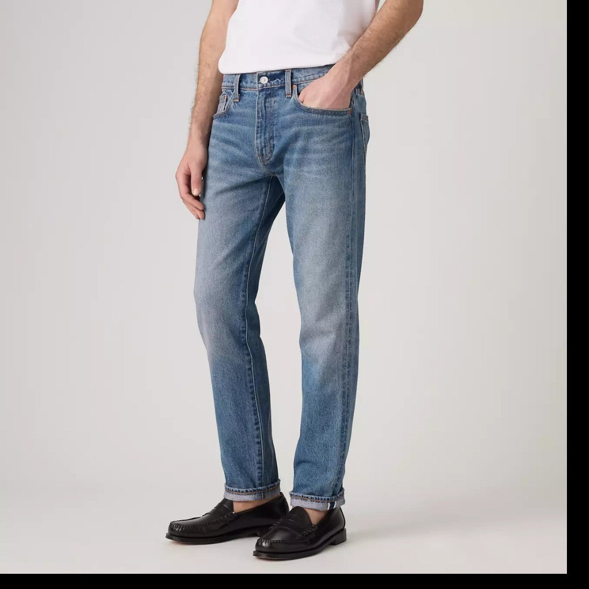 MILWORKS Levis 502 Taper selvedge jeans in a medium wash blue denim with a slim tapered fit worn by a model