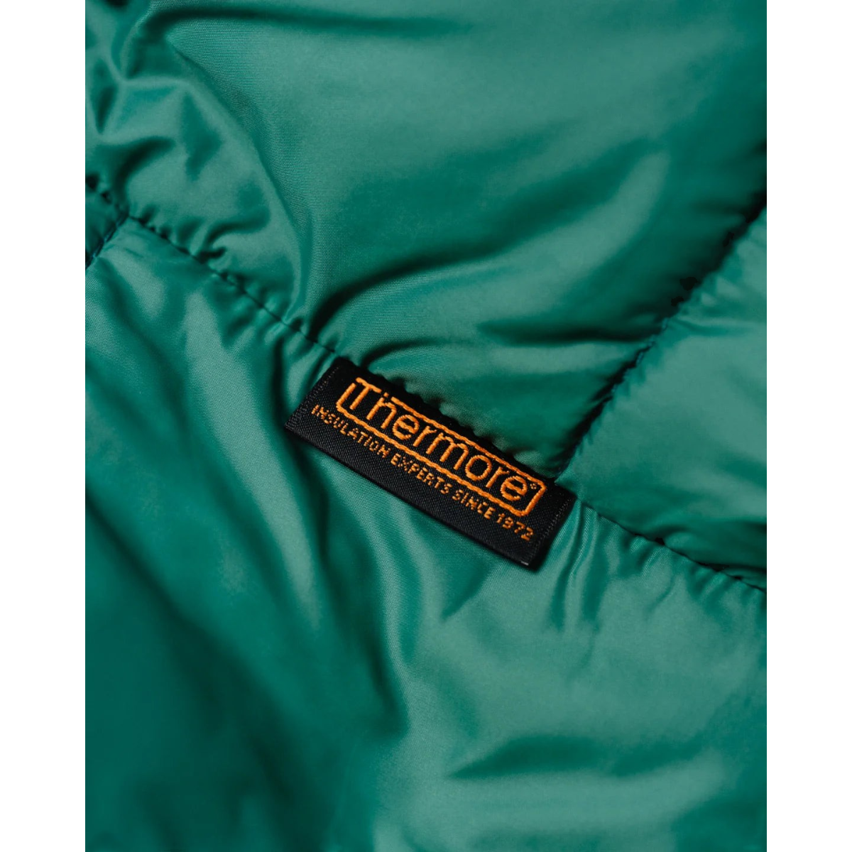 MILWORKS Minarets vest in pickle green nylon fabric with a Thermore Ecodown insulation label detail