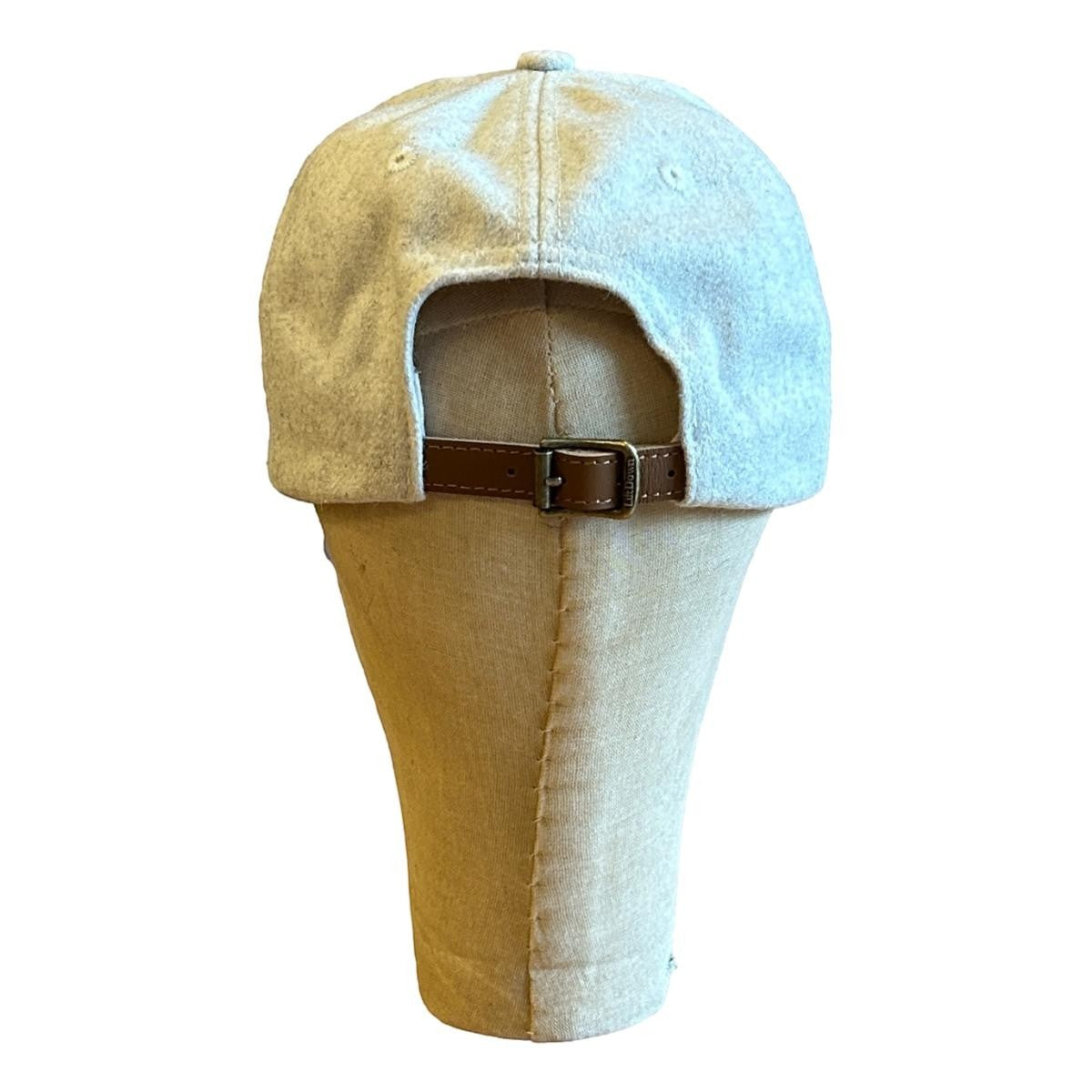 MILWORKS oat wool blend unstructured cap with adjustable leather strap and metal clasp. Felt "M" detail.