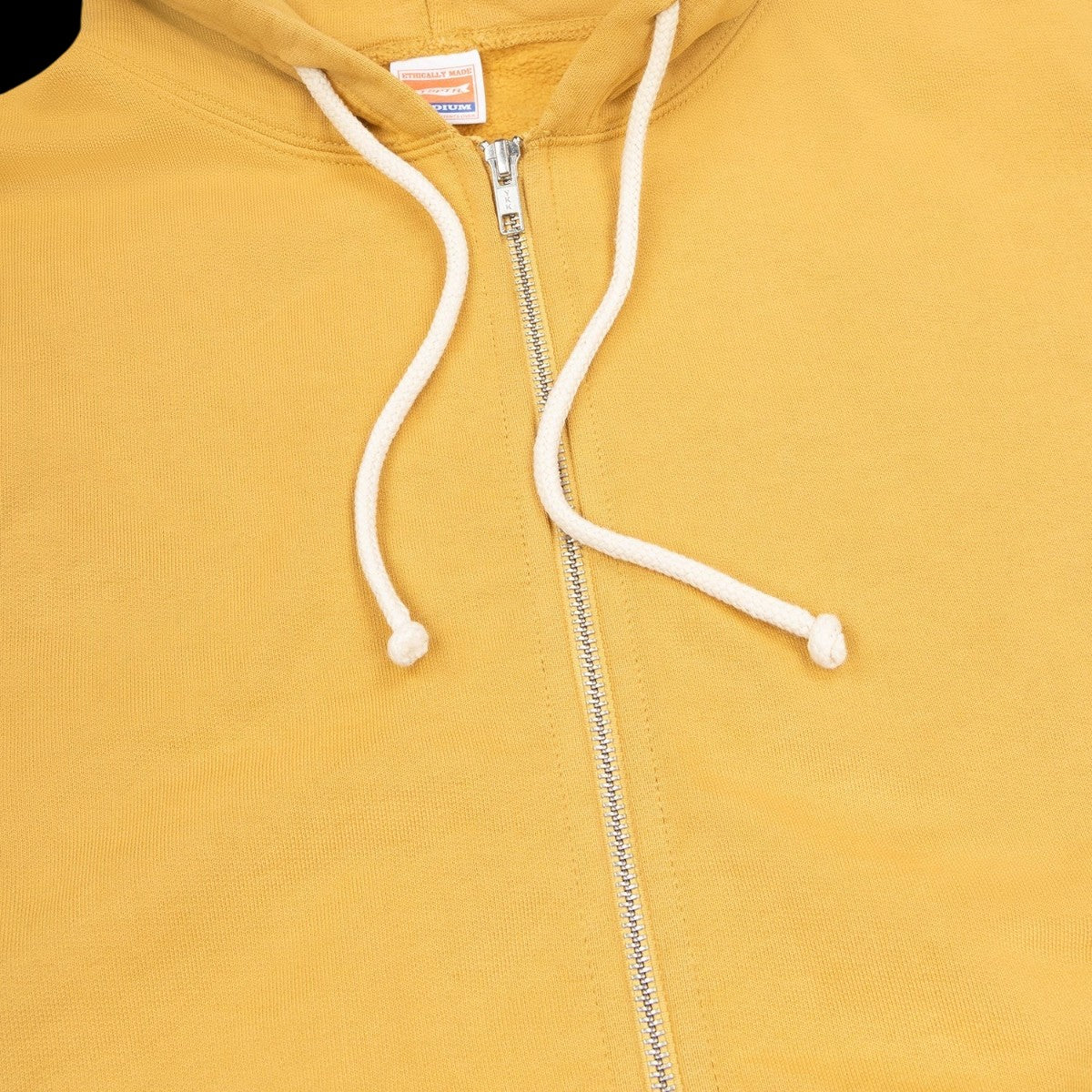 MILWORKS vintage ochre heavyweight cotton fleece zip-up hoodie with a double-lined hood and YKK zipper.