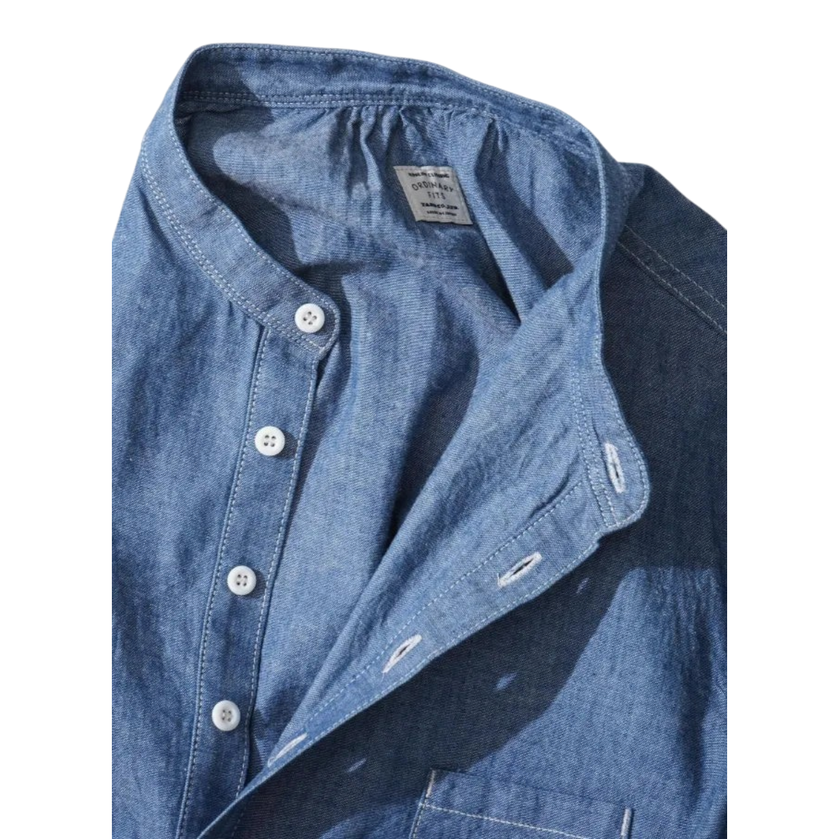 MILWORKS Ordinary Fits indigo chambray pullover work shirt with a band collar and white buttons.