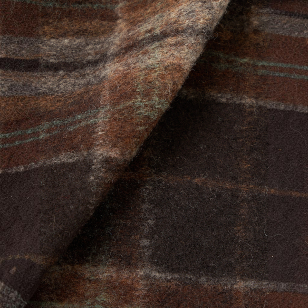 Close-up of the MILWORKS Pino wool fleece cardigan fabric featuring a brown and dark grey plaid check pattern.
