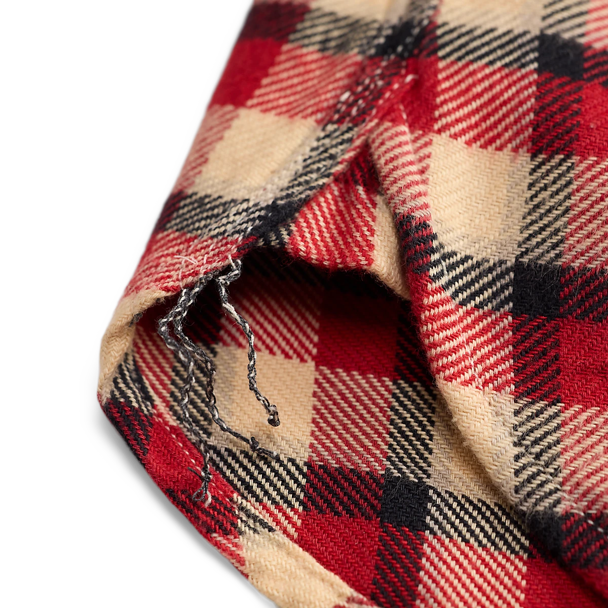 MILWORKS red and cream plaid cotton twill workshirt showing a close-up of the brushed fabric and hem detail