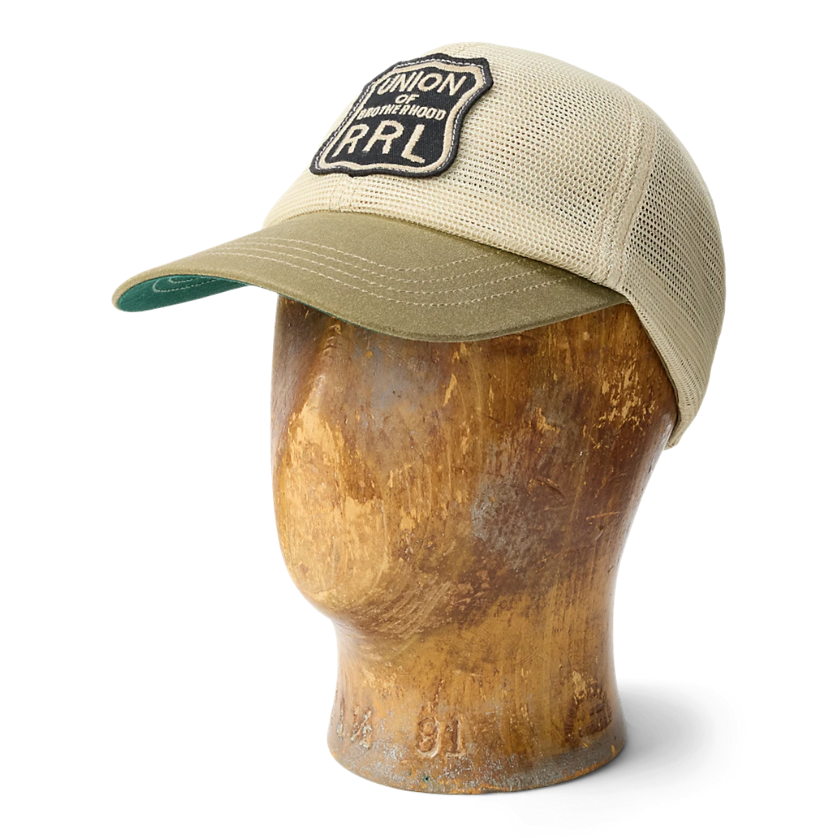 MILWORKS RRL brown and tan mesh trucker cap with a waxed canvas bill and embroidered logo patch on a wooden head form.