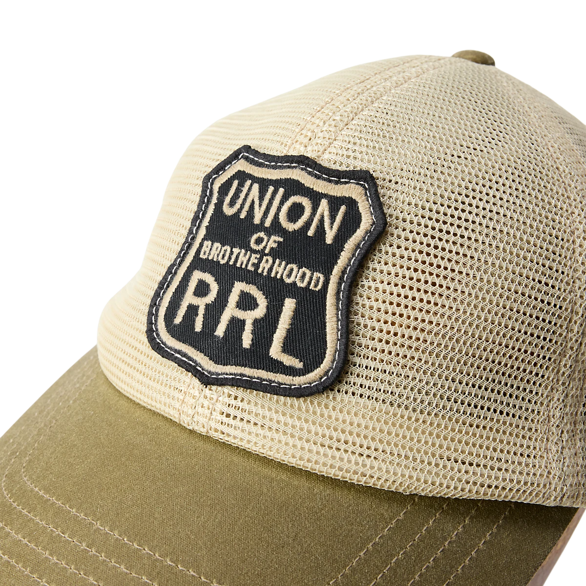 MILWORKS RRL trucker cap in tan mesh with a brown waxed canvas bill and embroidered Union of Brotherhood shield patch.