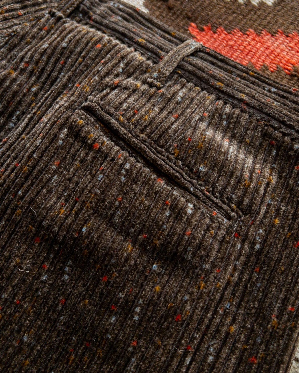 MILWORKS rustic brown wide wale corduroy chinos featuring a unique donegal flecked texture and a rear pocket detail.