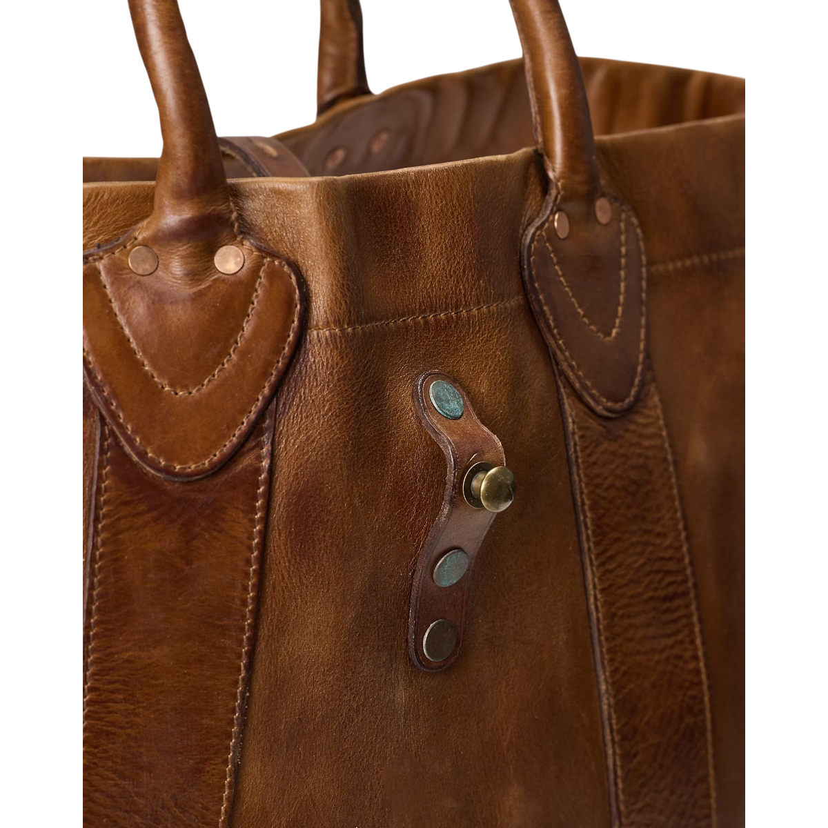 MILWORKS saddle brown leather tote bag with distressed finish, copper rivets, and vintage-style brass stud closure.