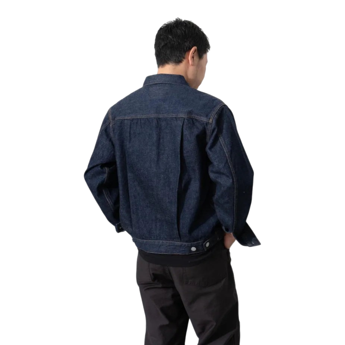 Back view of a man wearing a MILWORKS Type 2 once-washed dark indigo selvedge denim jacket with pleated details.