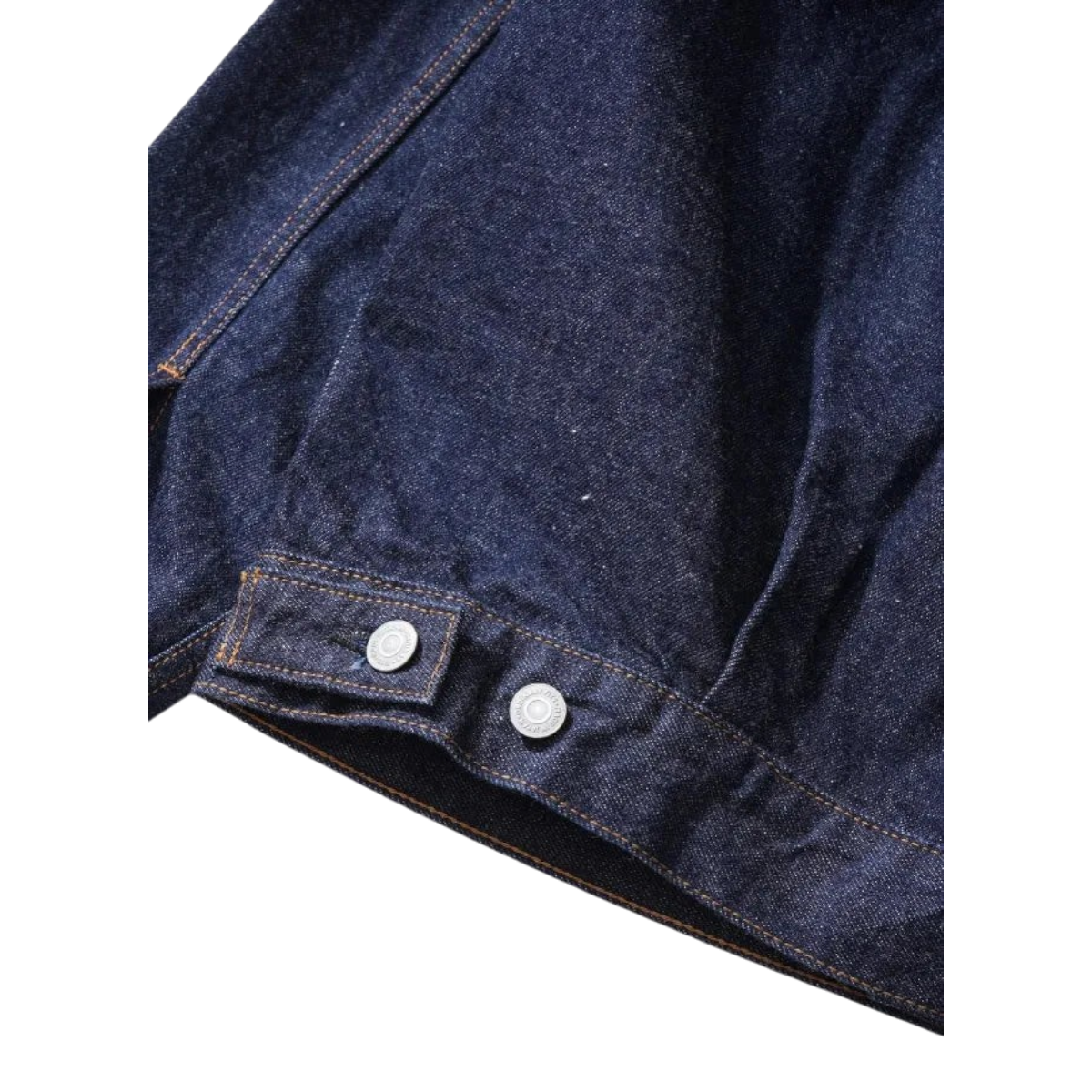MILWORKS Type 2 selvedge denim jacket in dark indigo with metallic button detail on the adjustable waist tab.