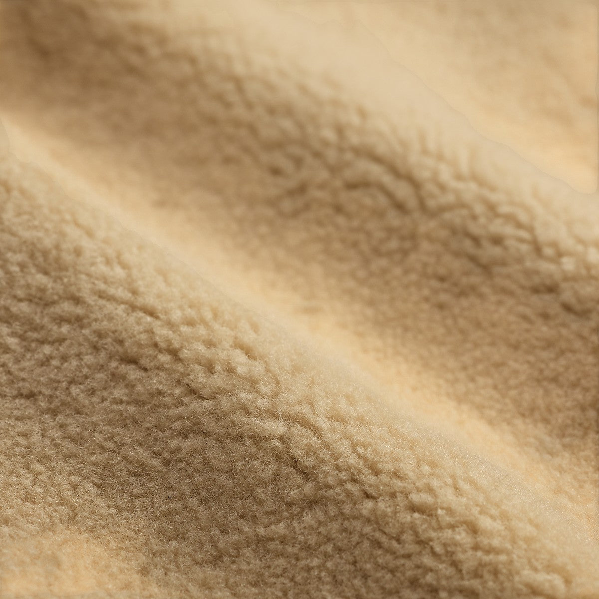 Close-up of the soft, cream-colored shearling lining from a MILWORKS RRL vintage brown moto jacket.