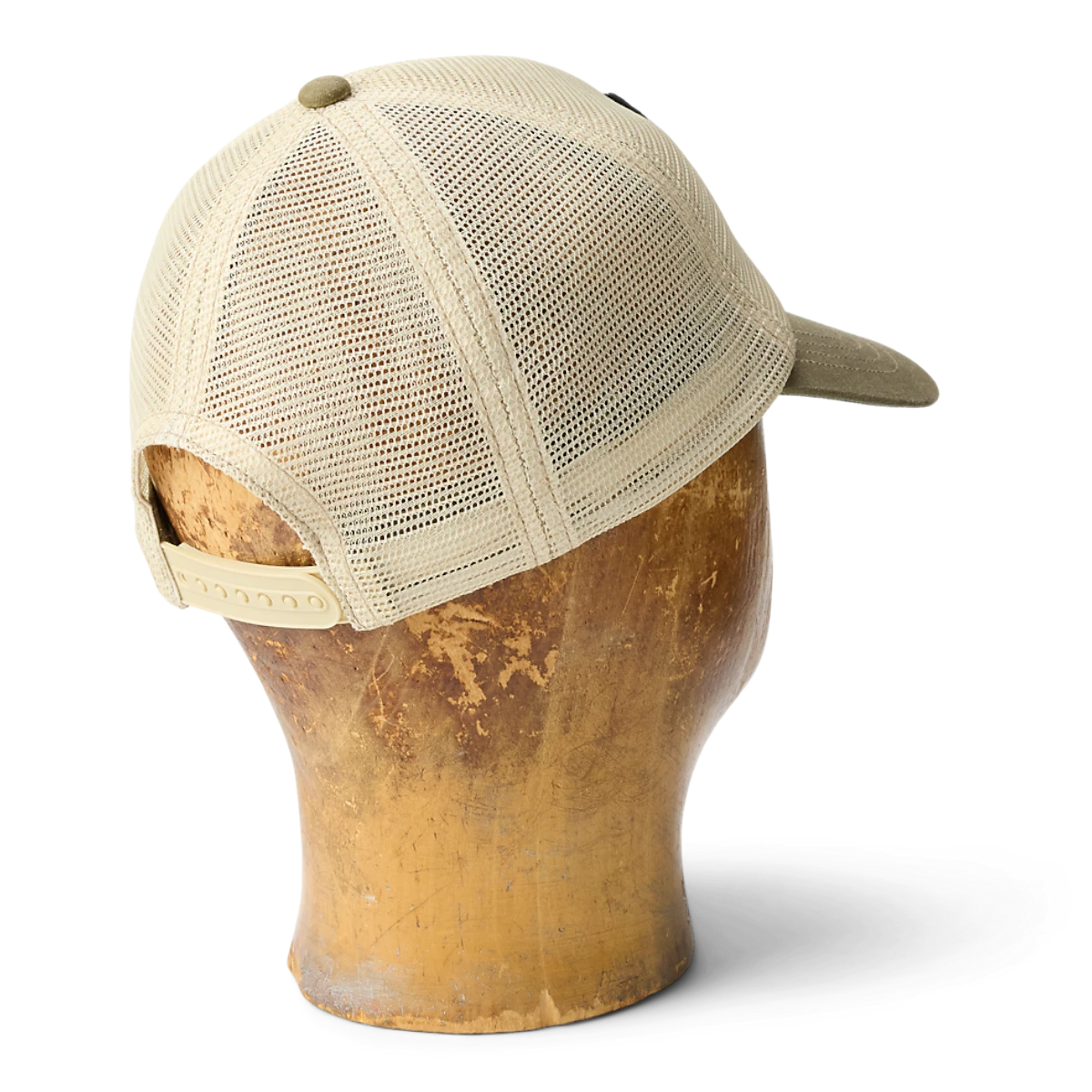 MILWORKS tan mesh trucker cap with adjustable snapback strap on a wooden mannequin head