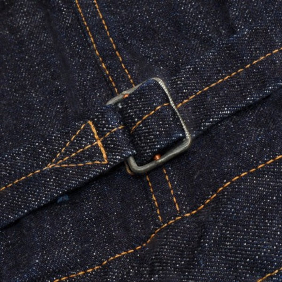 MILWORKS UES 17oz denim jacket back cinch buckle detail with contrast orange stitching on dark indigo fabric