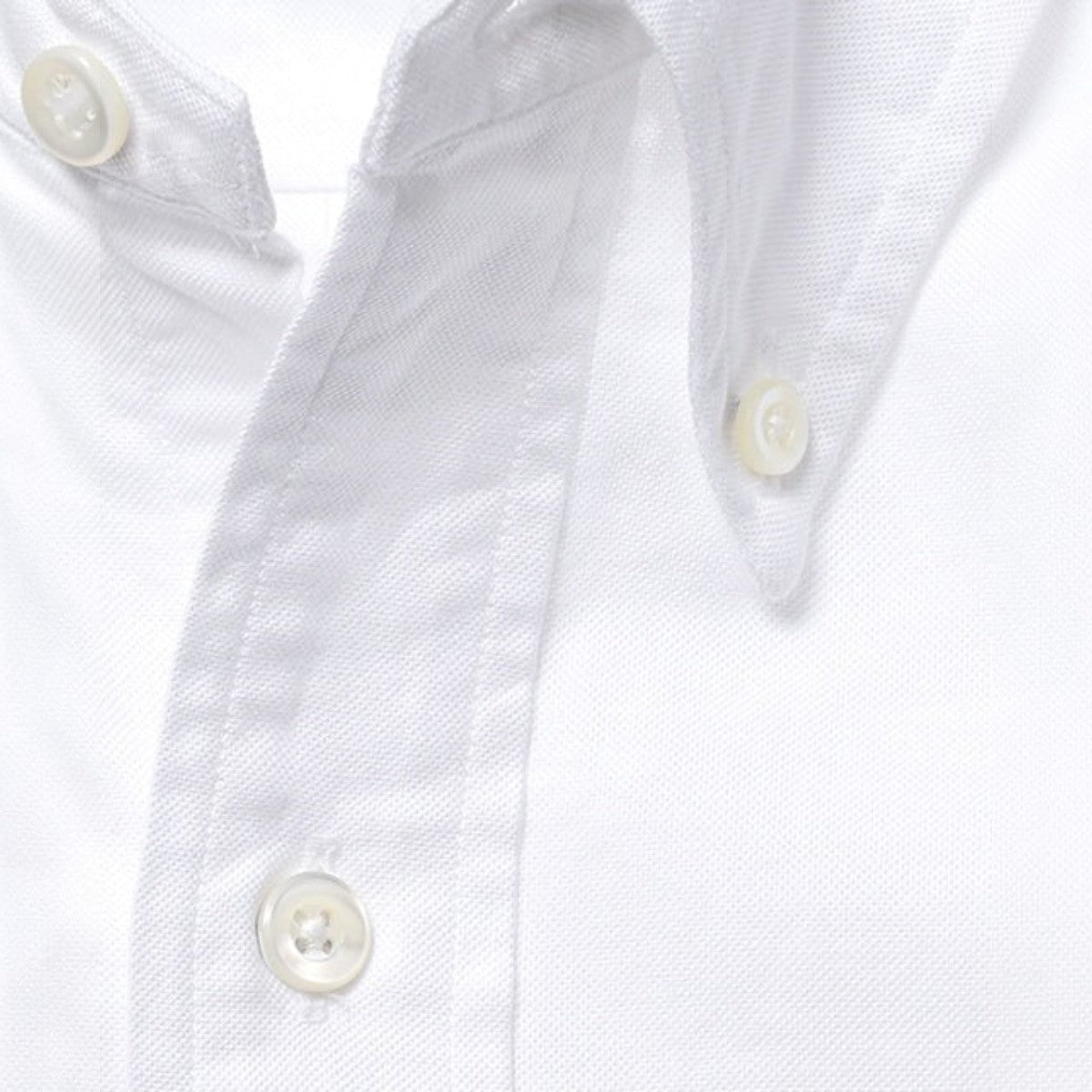 MILWORKS white cotton oxford button-down shirt featuring a classic collar with shell buttons and textured fabric.