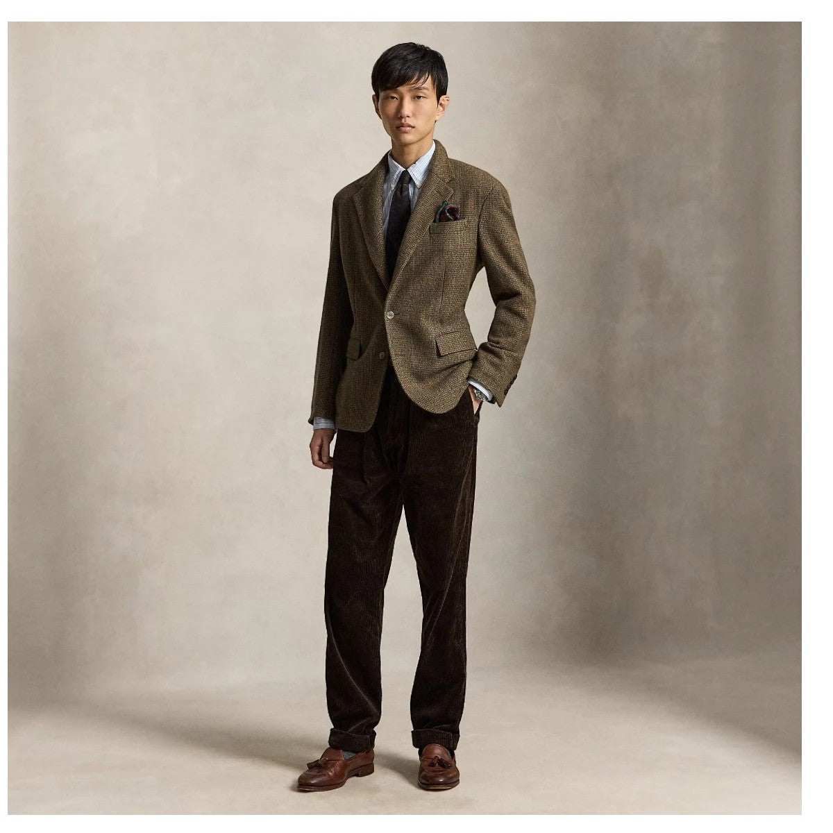 MILWORKS Whitman relaxed fit dark beech corduroy pants worn by a model with a tweed blazer and brown loafers