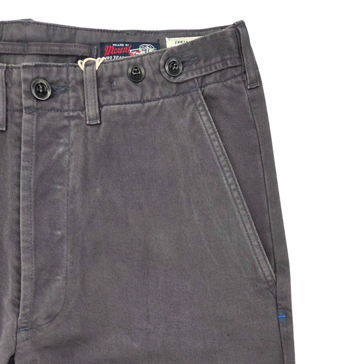 MILWORKS Wilkison trousers in washed charcoal featuring a flat-front design, side cinch tabs, and vintage buttons.