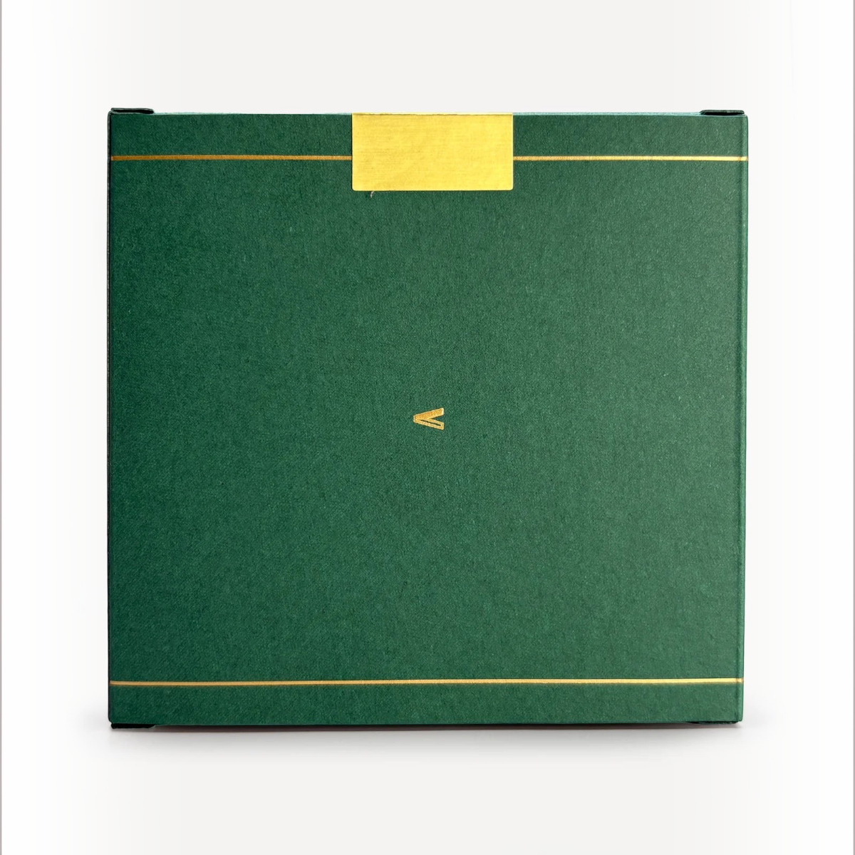 MILWORKS Youth perfume box in forest green with gold foil accents and a small V logo on a white background.