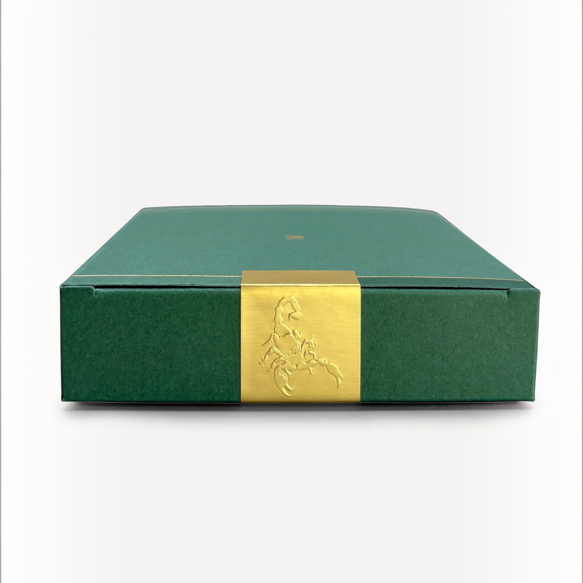 MILWORKS Youth perfume box in dark green with a gold foil scorpion emblem on the center band