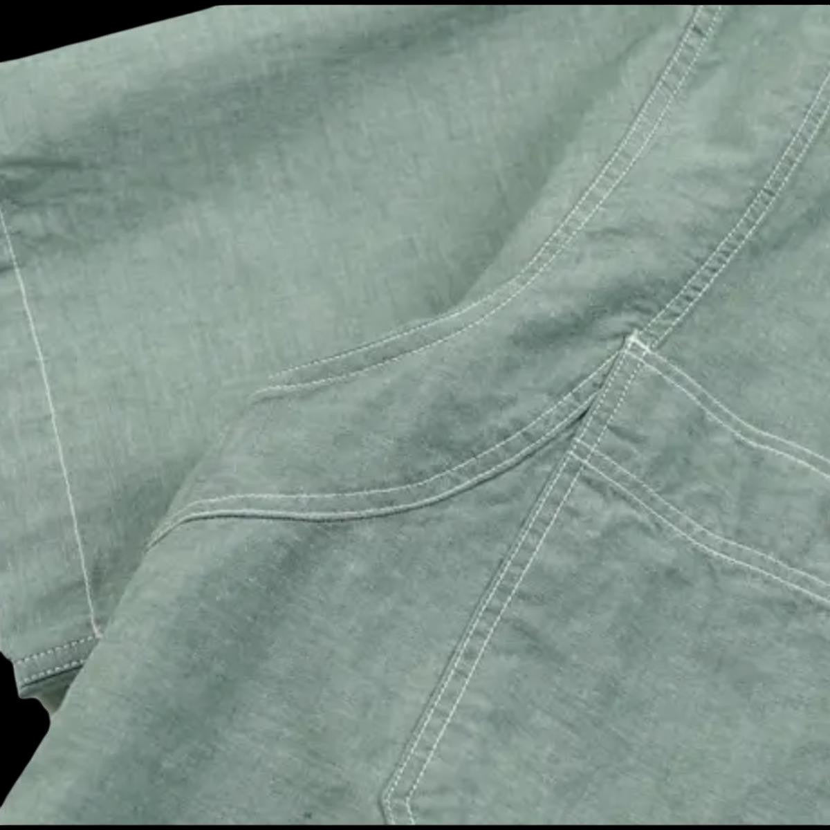MILWORKSH green cotton chambray work shirt with dual chest pockets and reinforced stitching. Relaxed fit.