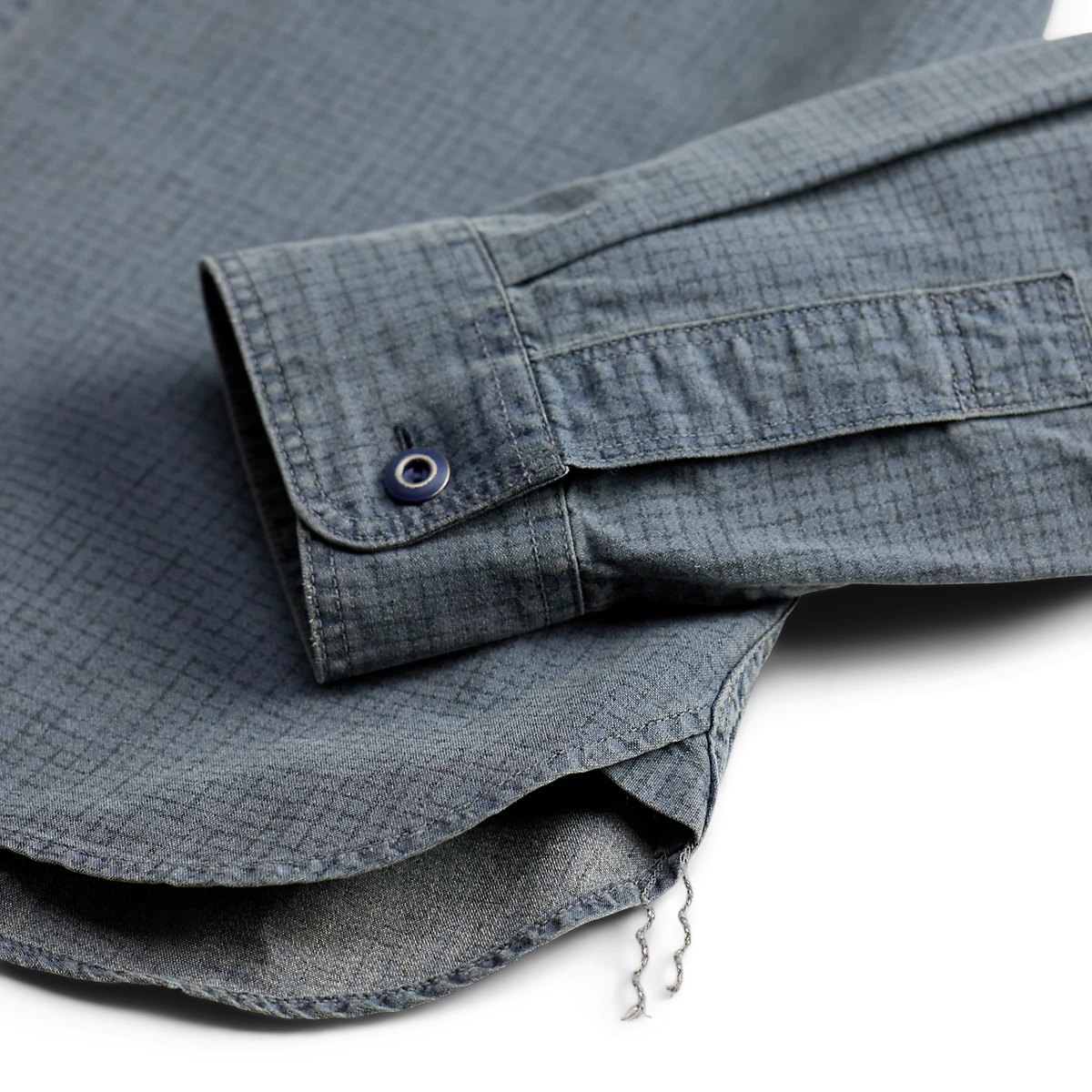 Double RL blue navy cotton workshirt featuring a checked motif, buttoned barrel cuff, and runoff chain-stitched hem.