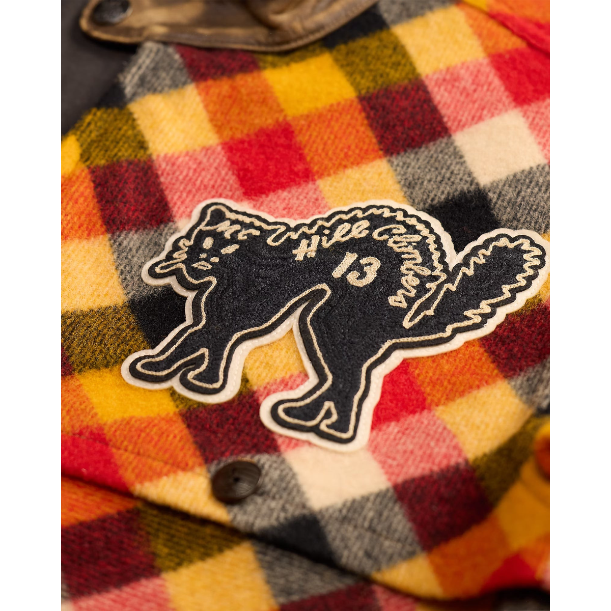 MILWORKS Cat-Patch Plaid Wool Overshirt featuring a black cat patch with Hill Climbers 13 embroidery on plaid wool